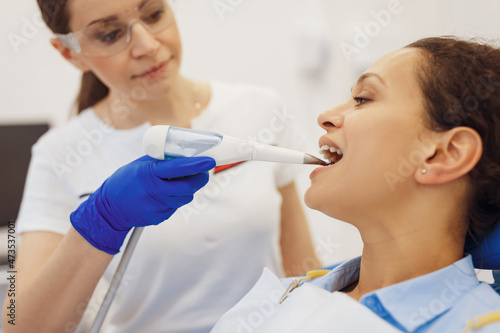 Doctor proving dental procedure with tools of client