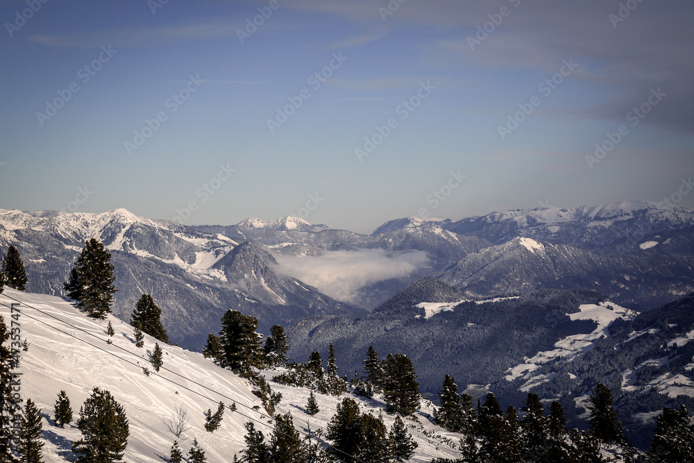 Winter landscape with mountains, forest and snow. Sports, recreation.