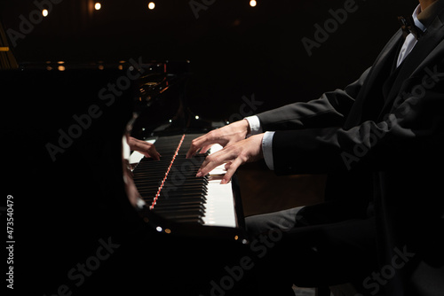 Man hands close up playing a piano.