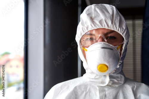 Female frontline worker wearing protective face mask at office photo