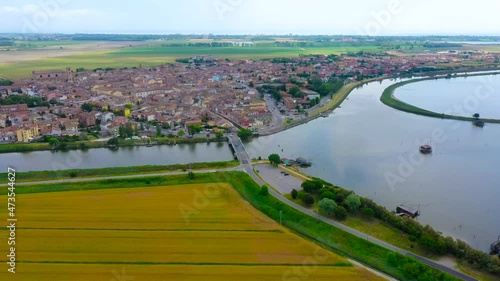 aerial 4k view of comacchio city, emilia romagna, italy, venice lagoon, fishermen city, city above water with bridges 