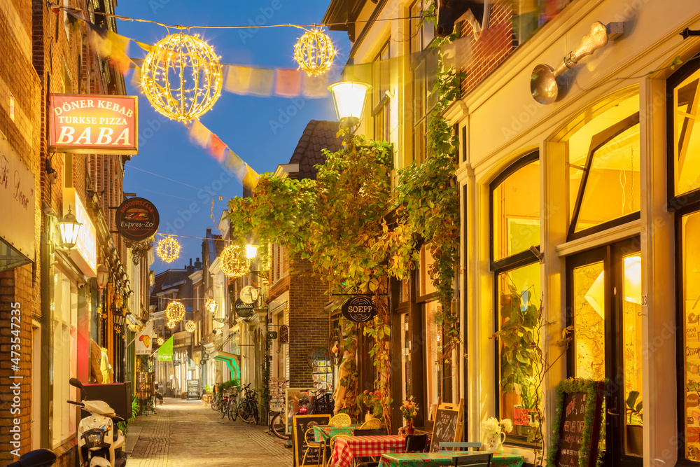 Colorful shopping street with christmas decoration in the ancient city center of Alkmaar, The Netherlands on November 10, 2021