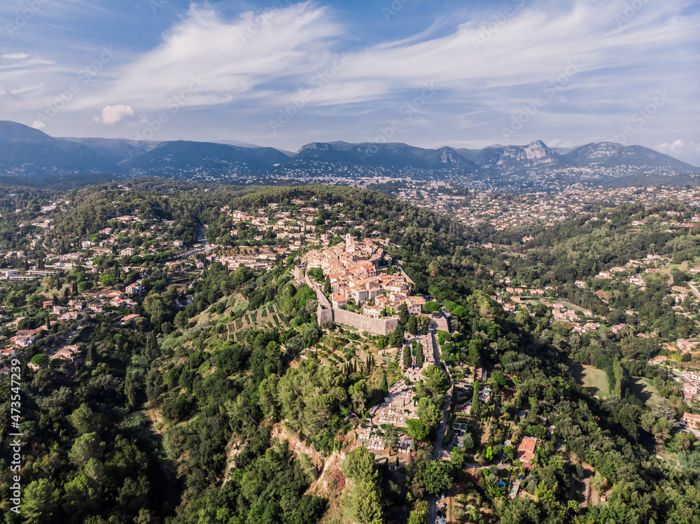Drone shot from Saint-Paul-de-Vence. Medieval fortified village in the south of France. The narrow picturesque streets of the village. Stone facades of the 16th-18th centuries. Green Hills. Chapel