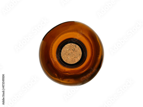 Empty medical bottle made of brown transparent glass, closed with a cork stopper. Isolated on a white background, top view