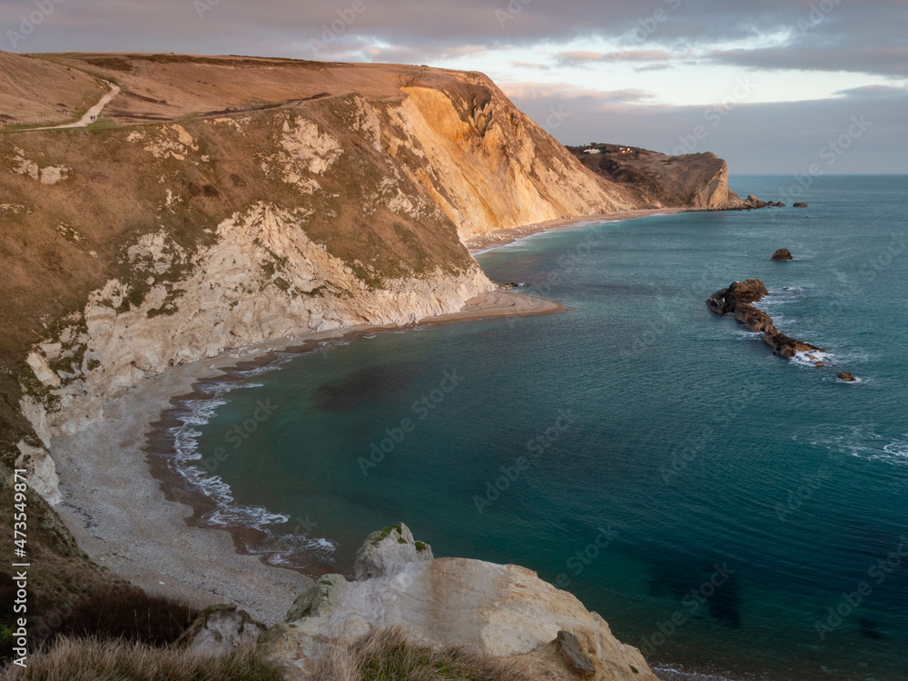 man o war cove Dorset England as the sun starts to go down on a bright winters day	
