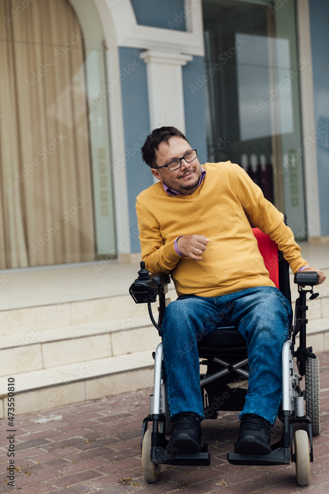 a man with a disability in a wheelchair on a walk on the street a man with a disability in a wheelchair on a walk on the street