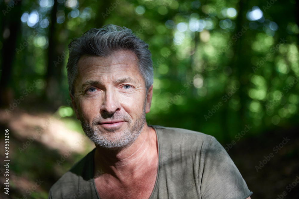 Handsome mature man with stubble at forest Handsome mature man with stubble at forest