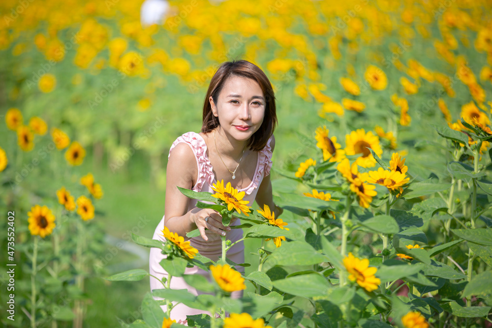 Asian woman at sunflower field portrait outdoor. Asian woman at sunflower field portrait outdoor.