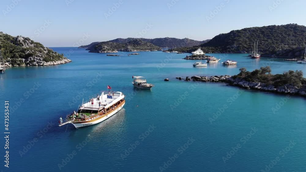 Drone shooting of the picturesque nature of the Turkish islands and the bay with turquoise sea water with sailing yachts on a rest Drone shooting of the picturesque nature of the Turkish islands and the bay with turquoise sea water with sailing yachts on a rest