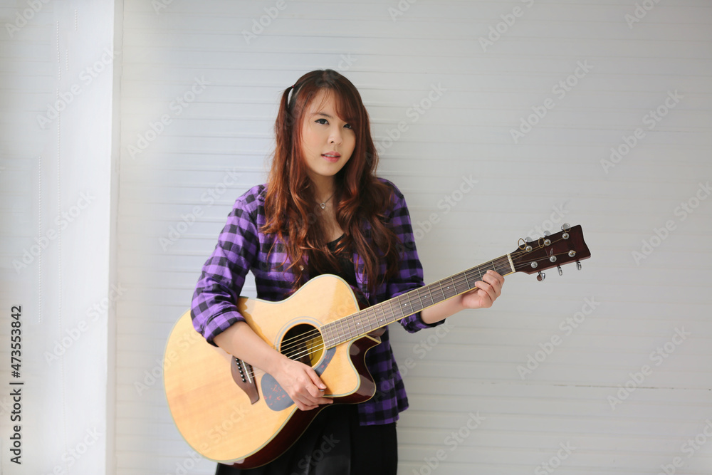 Girl singing on microphone and playing guitar Girl singing on microphone and playing guitar