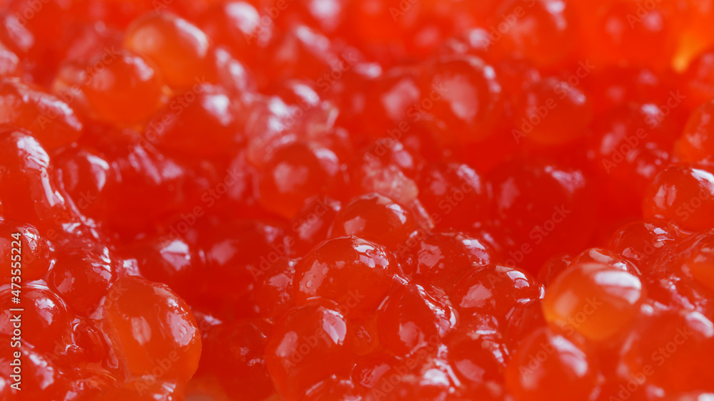 Red caviar. Bright background or backdrop. Wallpaper for a desktop with an aspect ratio of 16 to 9. Macro. Selective focusing Red caviar. Bright background or backdrop. Wallpaper for a desktop with an aspect ratio of 16 to 9. Macro. Selective focusing