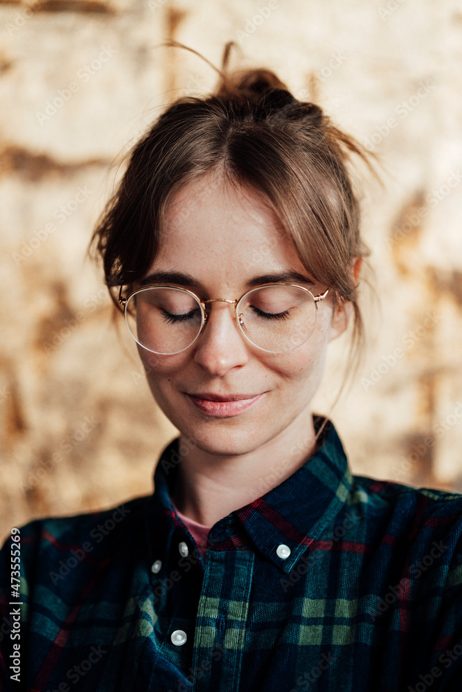 Young woman with eyes closed wearing eyeglasses Young woman with eyes closed wearing eyeglasses