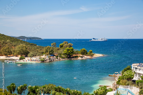 Albania, Vlore County, Ksamil, Albanian Riviera in summer with ferry sailing in background photo