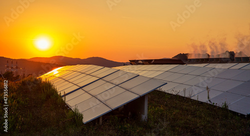 Sun setting over solar farm