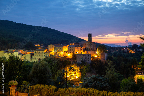 Italy, Province of Pisa, Sasso Pisano, Illuminated village at dusk