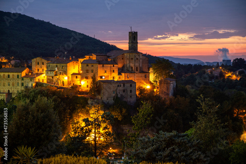 Italy, Province of Pisa,SassoPisano, Illuminated village at dusk photo