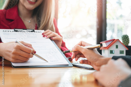 Business Signing a Contract Buy - sell house. Real estate agent offer home ownership sign a contract. photo