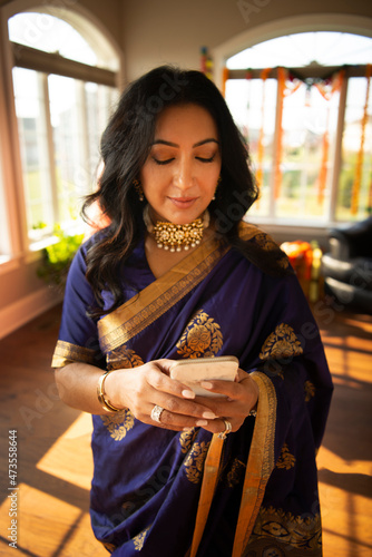 Indian woman in sari sending a text  photo