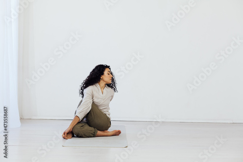 beautiful woman brunette engaged in yoga asana gymnastics exercises