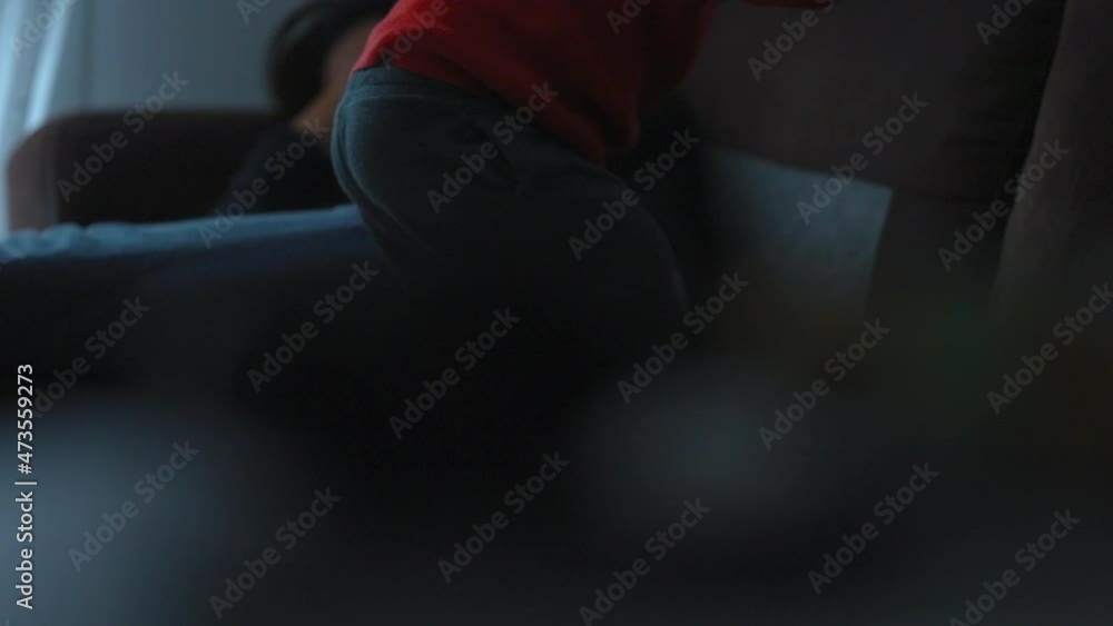 Active little boy jumping on sofa at home. Child jumps on top of couch Active little boy jumping on sofa at home. Child jumps on top of couch