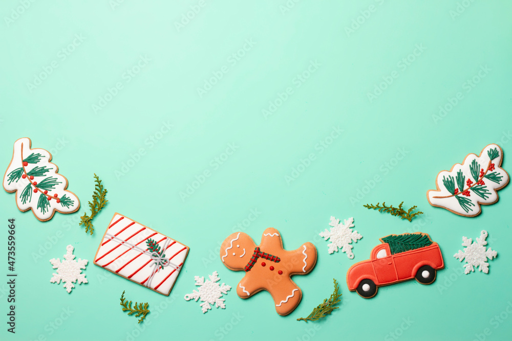 Christmas composition with decorations and cookies on a mint background