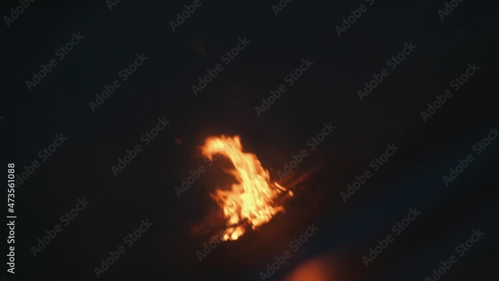 Blurred view of large tongues of flames of a campfire at dusk. Concept of rest and travel. Shooting tilted Blurred view of large tongues of flames of a campfire at dusk. Concept of rest and travel. Shooting tilted