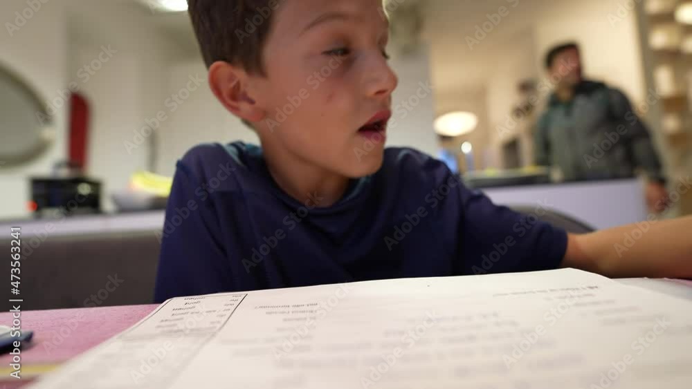 Boy doing homework focused in exam preparation Boy doing homework focused in exam preparation