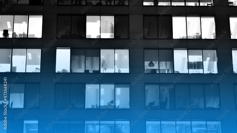 Corporate building at night - business concept. Glass wall office building .Modern office windows of skyscraper glowing at night. Black amd white. Corporate building at night - business concept. Glass wall office building .Modern office windows of skyscraper glowing at night. Black amd white.