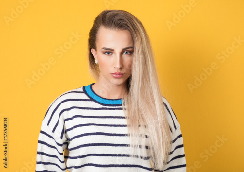 Head and shoulders shot of gorgeous young woman, isolated on yellow background. Front view. Close up face of beautiful girl © Alen-D
