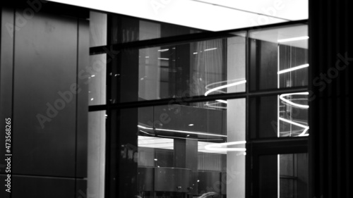 Skyscraper lobby in  business district. Big glass windows in commercial skyscraper at night. Black and white. © Grand Warszawski