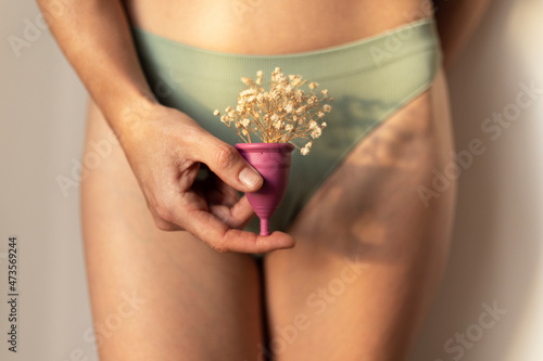 Woman holding menstrual cup photo