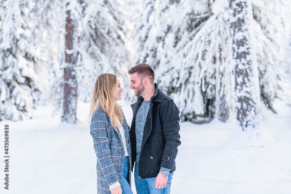 Smiling couple looking at each other during winter Smiling couple looking at each other during winter