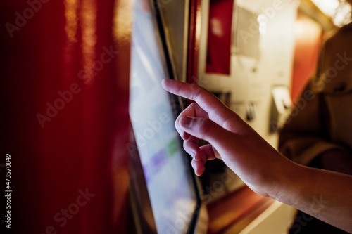 Hand using ticket machine at subway station photo