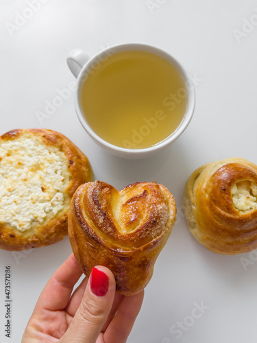 Morning tea with delicious buns. Cup of hot tea with delicious buns for tea drinking