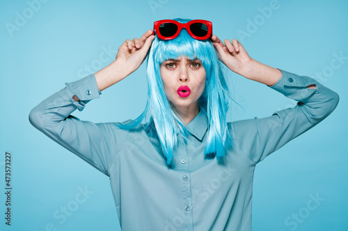 attractive woman in purple wig red glasses posing close-up