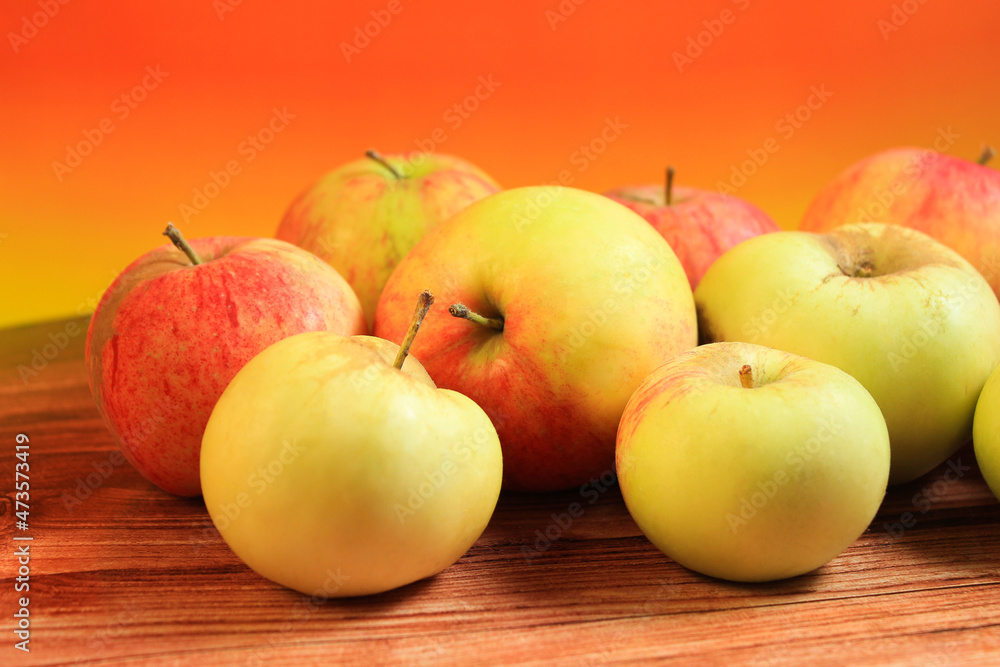 red and yellow apples on an orange background. fruits, healthy lifestyle, healthy food red and yellow apples on an orange background. fruits, healthy lifestyle, healthy food