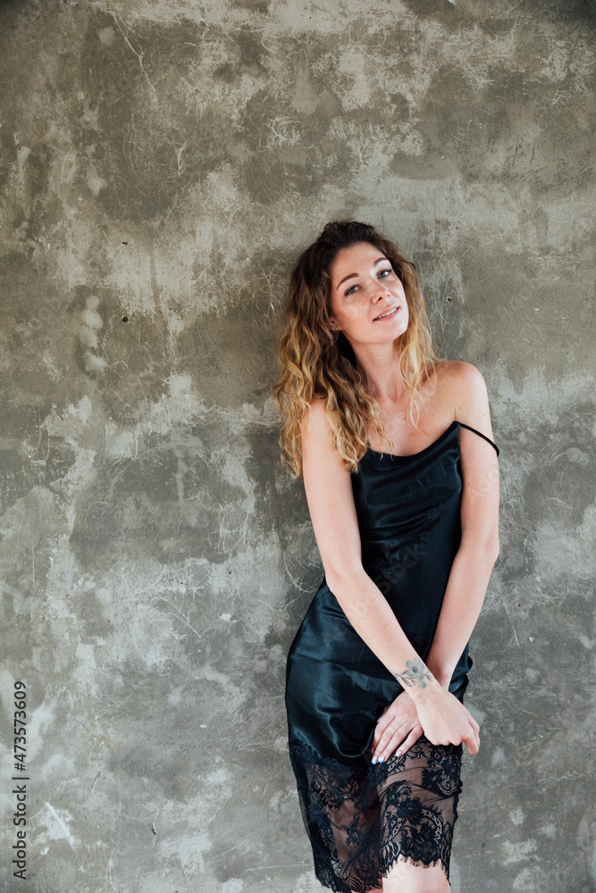portrait of a beautiful blonde woman in a black silk dress portrait of a beautiful blonde woman in a black silk dress
