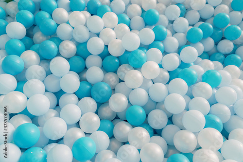 Plastic balls for game in pool. White and blue Background