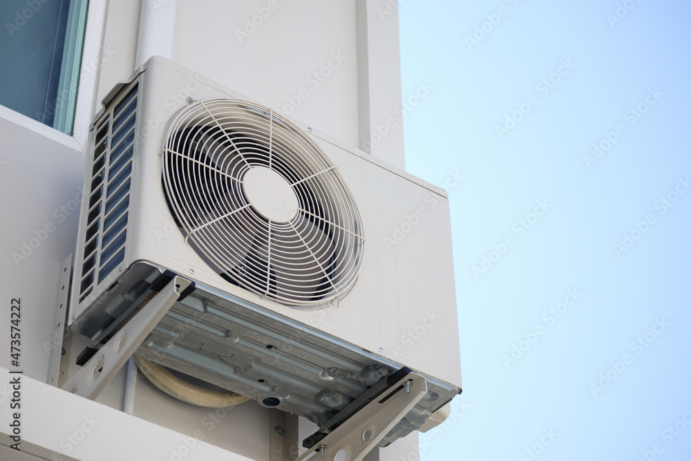 Air condition outdoor unit compressor install outside the house with blue sky Air condition outdoor unit compressor install outside the house with blue sky