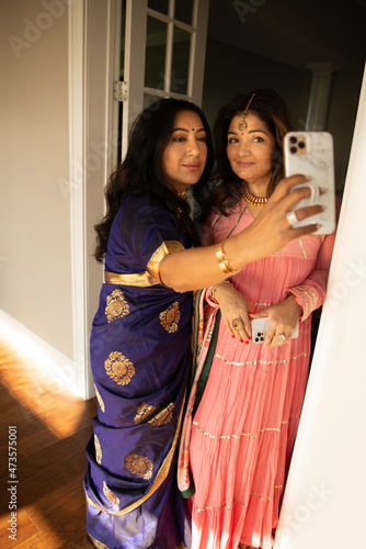 Indian women dressed up taking a selfie  photo