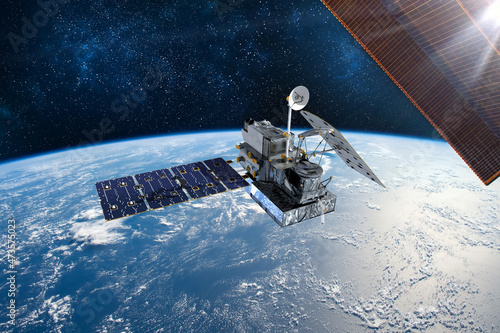 Fototapeta Naklejka Na Ścianę i Meble -  Cargo space craft and Earth planet. Dark background. Sci-fi wallpaper.Space Station Orbiting Earth.Space ship. Space art wallpaper.Solar Observatory.Elements of this image furnished by NASA.