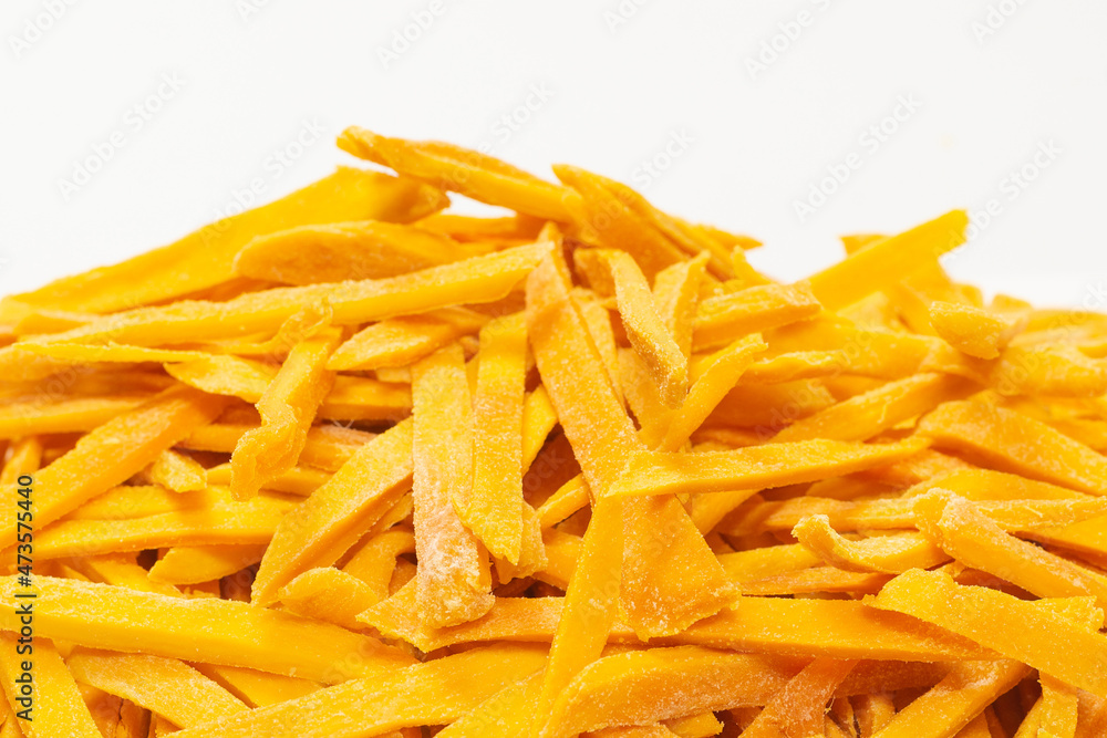 Fototapeta premium Dry tasty mango slices as a background.