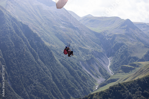 Paragliding with a pair of instructors. Mountains landscape panorama