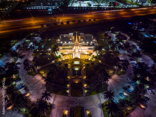 wide shot of mormon temple at night from a drone