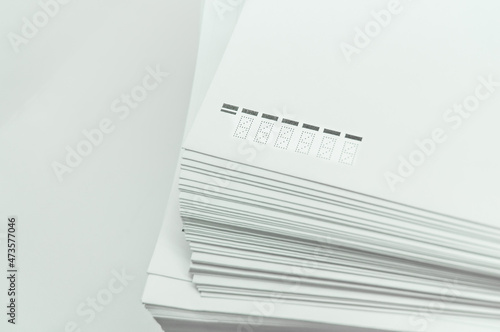 A stack of large white postal envelopes. Packaging for letters and documents. Postal supplies. Selective focus
