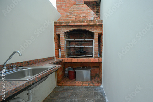 Red brick BBQ corner. Photo of open fire place wide angel