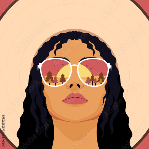 Chic trendy woman wearing sunglasses watching sunset