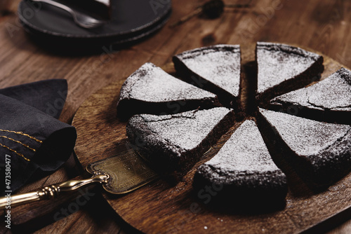 Kladdkaka. Traditional Swedish moist chocolate cake on wooden table. Fika. Hygge. Winter treat