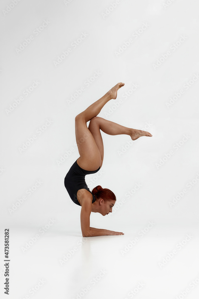 Attractive girl dancing ballet on white background