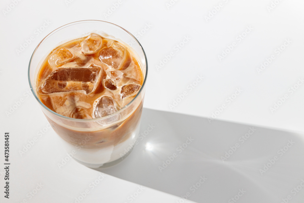Latte or cappuccino with ice in cup
